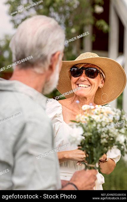 Happy mature woman looking at man