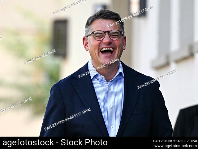 08 October 2023, Hesse, Frankfurt/Main: Boris Rhein, CDU top candidate and Minister President of Hesse, accompanies his wife to vote at the polling station in...