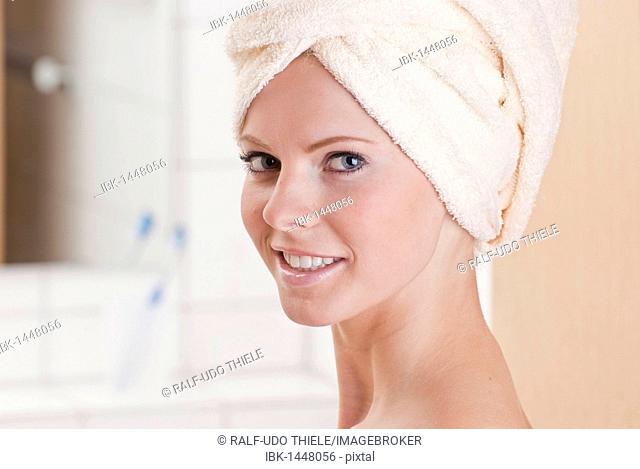 Young woman with a towel wrapped around her head