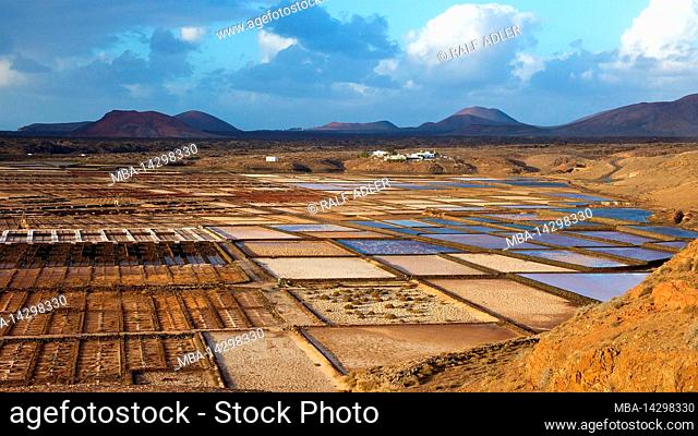 Canary Islands, Lanzarote, volcanic island, salt pans, seen from oblique above, in the background the mountains of Timanfaya National Park