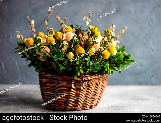 Easter card concept with floral composition with boxwood and colored eggs