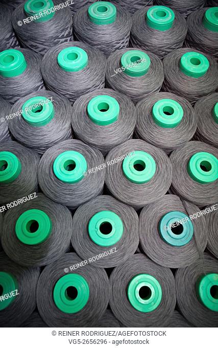 production of fine woolen fabrics for suits - in a factory in Sabadell, Spain. rolls of woolen threads