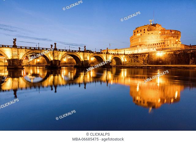 Dusk on the ancient palace of Castel Sant'Angelo with statues of angels on the bridge on Tiber RIver Rome Lazio Italy Europe