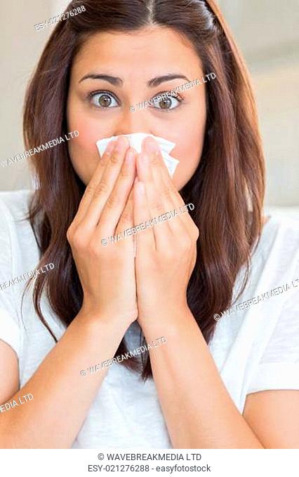 Brunette with runny nose at home