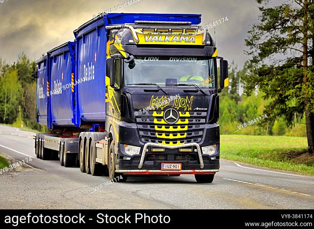 Beautifully customised Mercedes-Benz Arocs hooklift truck Lead Lion of Maanrakennus Valkama Oy pulls Delete trailers. Jokioinen, Finland. May 14, 2021