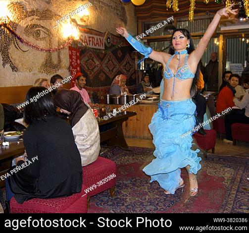 Traveling around Istanbul. Woman dancing belly dance inside a restaurant