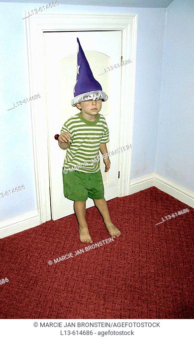 Child wearing a wizard hat