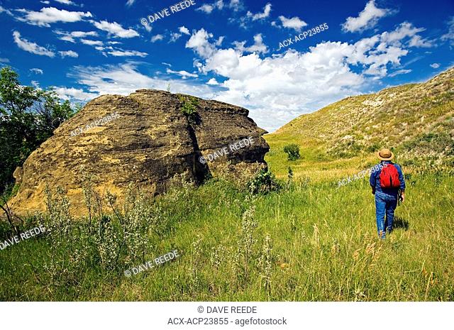 hiker, rock formations near Roche Percee, Souris River Valley, Saskatchewan, Canada