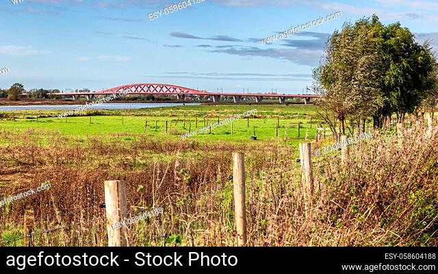 Scenic view Red railroad bridge Hanzeboog over the IJssel river at the entrance of Zwolle in the Netherlands