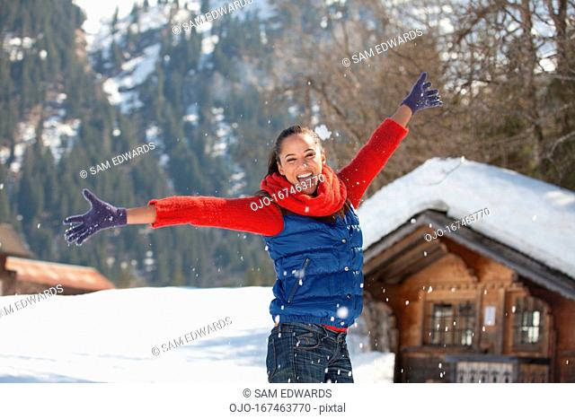 Happy woman throwing snow