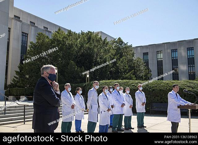 White House Chief of Staff Mark Meadows, left, listens while CDR Sean P. Conley, MD, Physician to the President, provides an update on the condition of United...