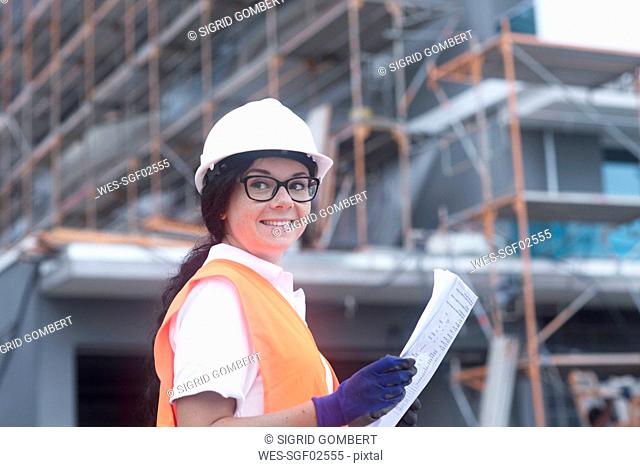 Female construction engineer checking the construction of a new house