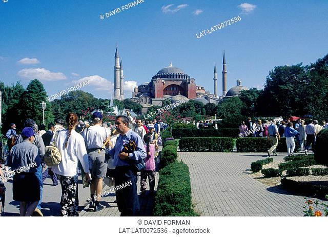 Hagia Sofia/ Aya Sofya/ Sancta Sophia. Red-walled building. Minarets. Gardens. People