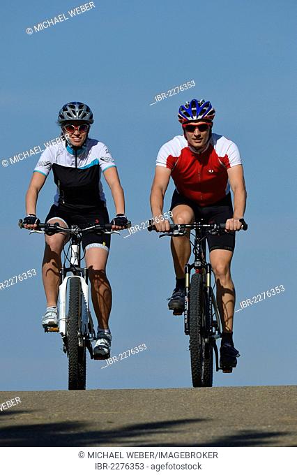 Couple, male and female cyclists riding mountain bikes, bicycles, Stuttgart, Baden-Wuerttemberg, Germany, Europe, PublicGround