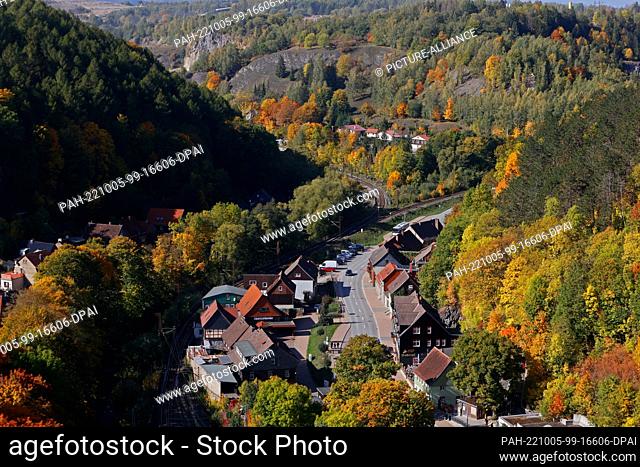 05 October 2022, Saxony-Anhalt, Rübeland: Autumn colored trees form the backdrop for the Harz village of Rübeland. The cave village of Rübeland is a district of...
