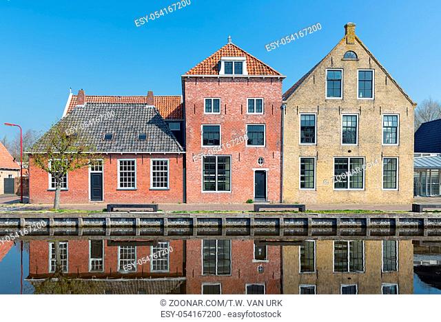 Facade of Houses along a canal in Makkum, an old Dutch village in Friesland