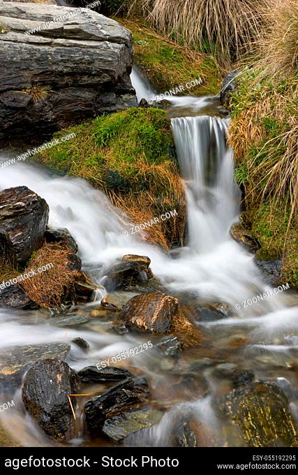 Water flows over rocks at the Remarkables, near Queenstown, New Zealand