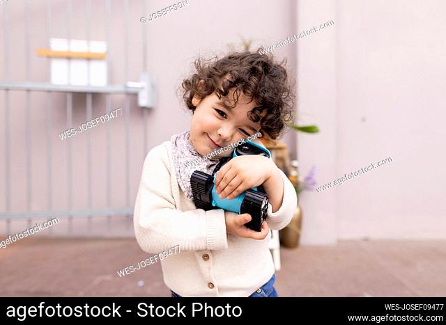 Little girl hugging AI toy robot