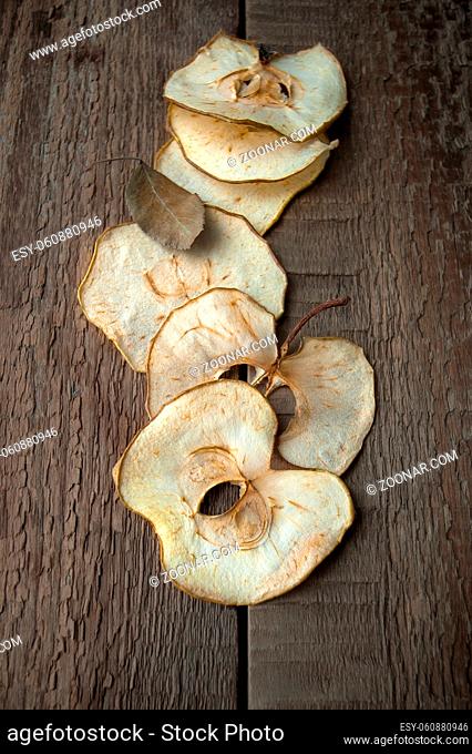 Apple chips on an old wooden table