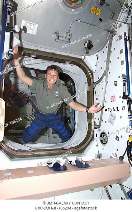 Astronaut Peggy A. Whitson, Expedition Five flight engineer, floats through a hatch into the Unity node on the International Space Station (ISS)