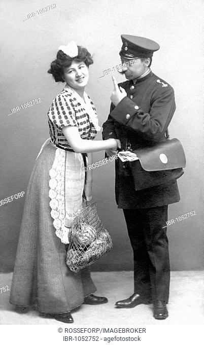 Historic photograph, postman flirting with maid, around 1920