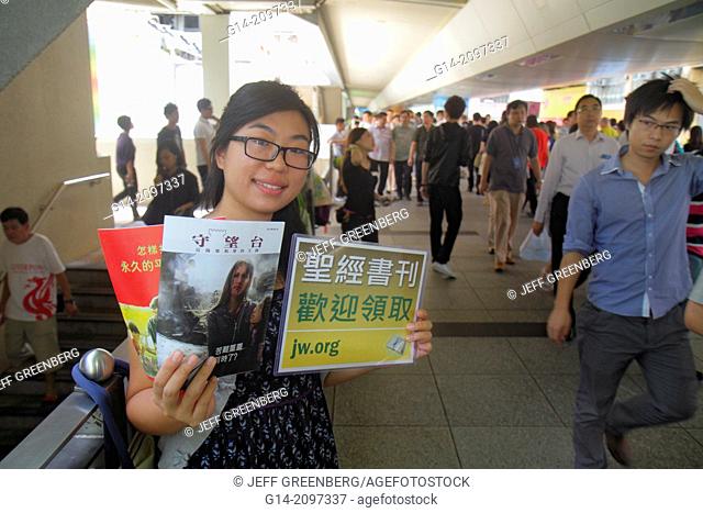 China, Hong Kong, Island, Wan Chai, raised pedestrian walkway, Asian, woman, holding poster, advertising, Cantonese Chinese characters hànzì pinyin