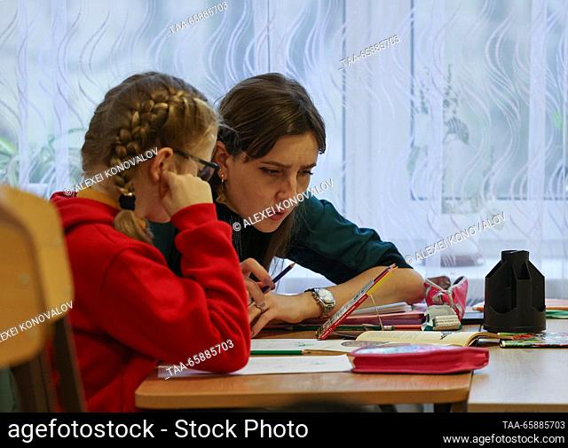 RUSSIA, ZAPOROZHYE REGION - DECEMBER 18, 2023: A teacher and a pupil at school No 4 in the town of Pologi. The school has 440 students who come from nearby...