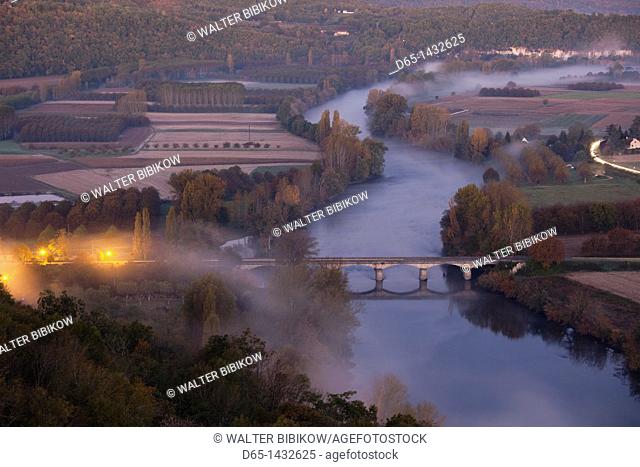 France, Aquitaine Region, Dordogne Department, Domme, elevated view of the Dordogne River Valley in fog from the Belvedere de la Barre, dawn