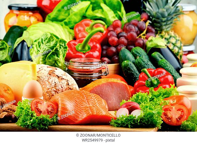 Variety of organic food including vegetables fruit bread dairy and meat. Balanced diet