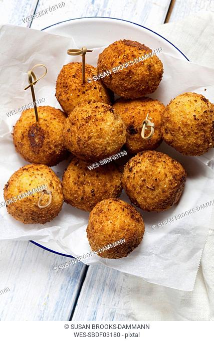 Arancini with skewers on a plate