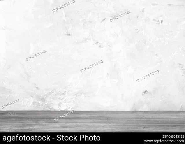 gray wooden flooring and gray concrete wall on background (focus on a wooden board in the foreground)