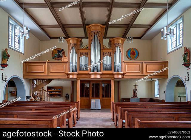 SCHMALLENBERG, GERMANY - JUNE 8, 2020: View throught the main aisle to the organ of the parish church Saint Blasius on June 8, 2020 in Schmallenberg, Germany