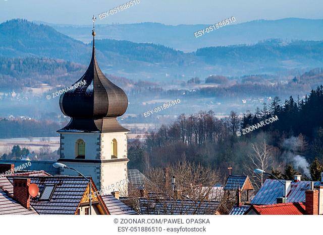 Rooftops of houses and the tower of the catholic church of the Parafia Nawiedzenia NMP in Karpacz, Poland
