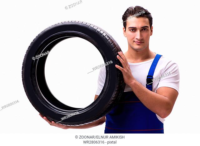 Handsome tyre repairman isolated on white