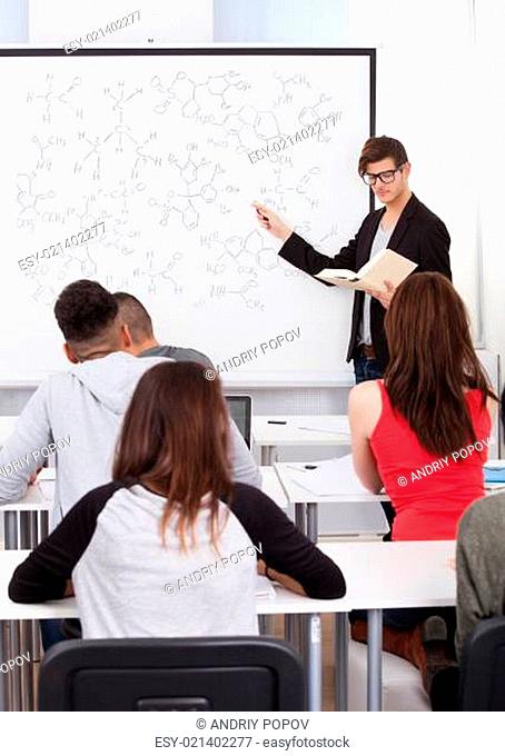 Teacher Teaching Chemical Formulas To College Students