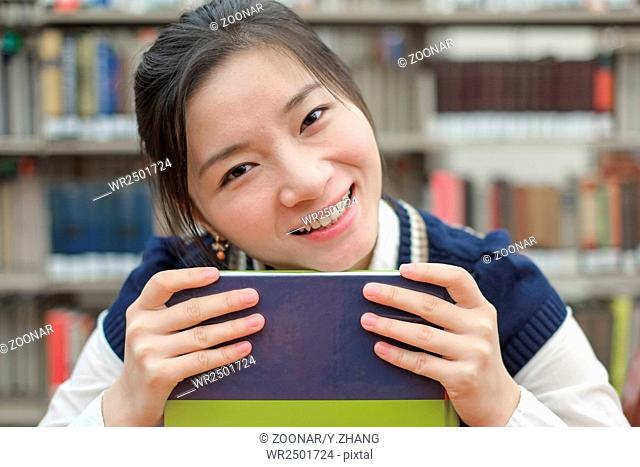 Student resting her chin on textbook