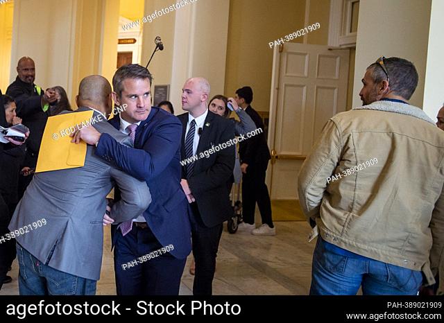 Former Capitol Police Sergeant Aquilino Gonell, left, is embraced by United States Representative Adam Kinzinger (Republican of Illinois), center