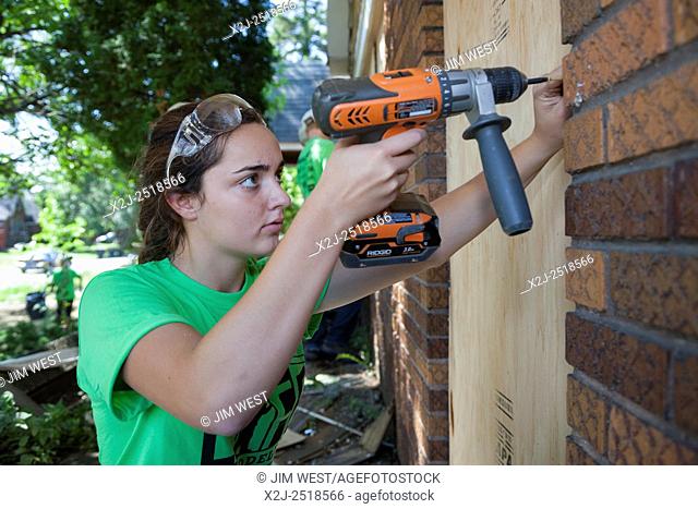 Detroit, Michigan - Volunteers from Life Remodeled, a nonprofit organization, board up vacant houses around Osborn High School as part of an effort to improve...
