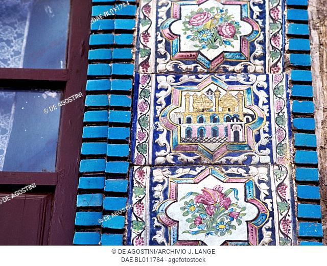 Decoration with floral motifs and view of a mosque, polychrome tile decorations in Tekyeh Mo'aven ol-Molk, Kermanshah, Iran