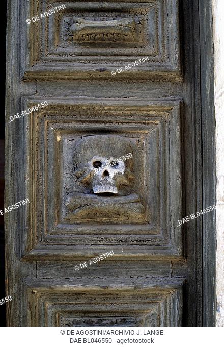 Skull carved on the door of the Church of Purgatory, Matera, Basilicata. Italy, 18th century