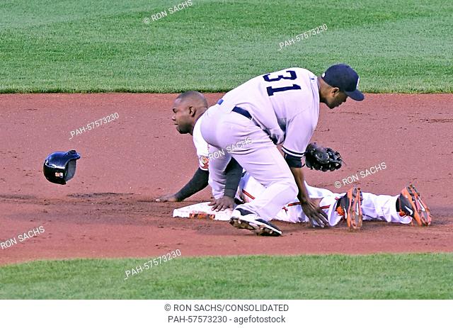 New York Yankees second baseman Gregorio Petit (31) tags out Baltimore Orioles left fielder Alejandro De Aza (12) as he tried to steal second base in the first...