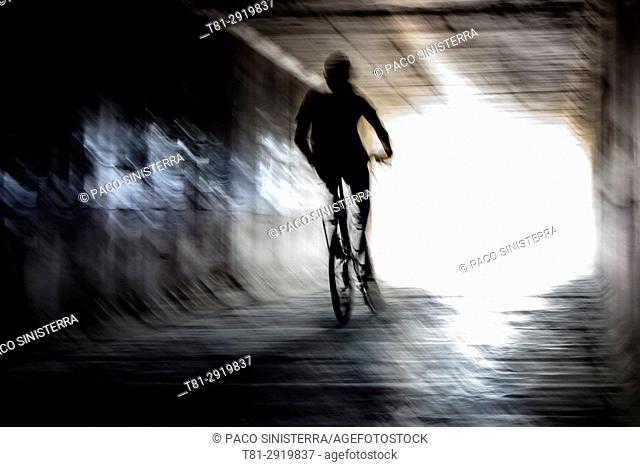 Boy on a bike crossing a tunnel, Alboraya, Spain
