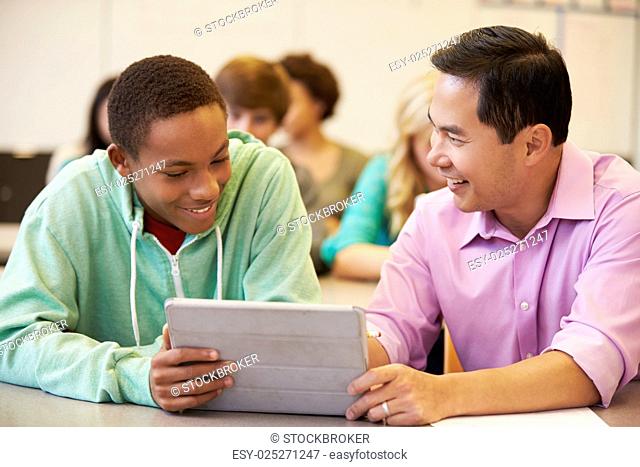 High School Student With Teacher Using Digital Tablet
