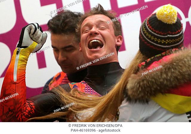 Felix Loch of Germany celebrates next to his girl friend Lisa after winning the gold medal after the Men's Singles Run 4 in Sliding Center Sanki at the Sochi...