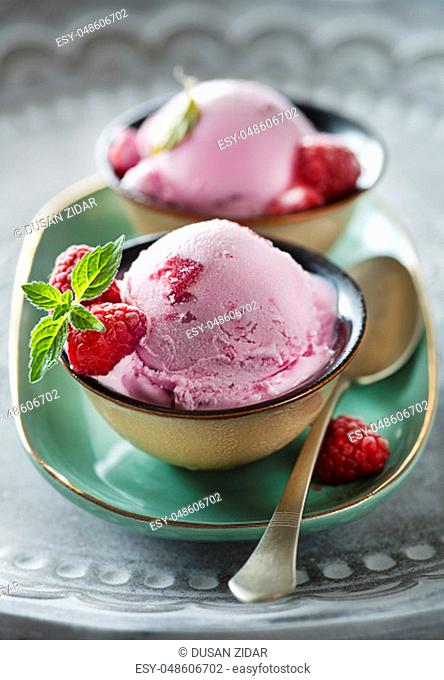 Homemade organic ice cream scoops with berries and raspberry