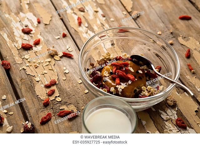 Breakfast cereals and milk on wooden table