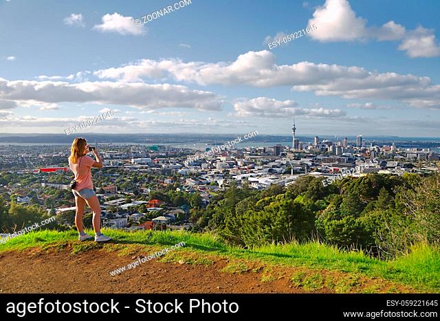 Tourist taking photos of the view of Auckland, New Zealand