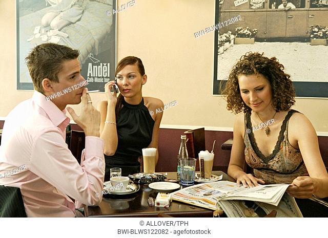 young people talking at a cafe