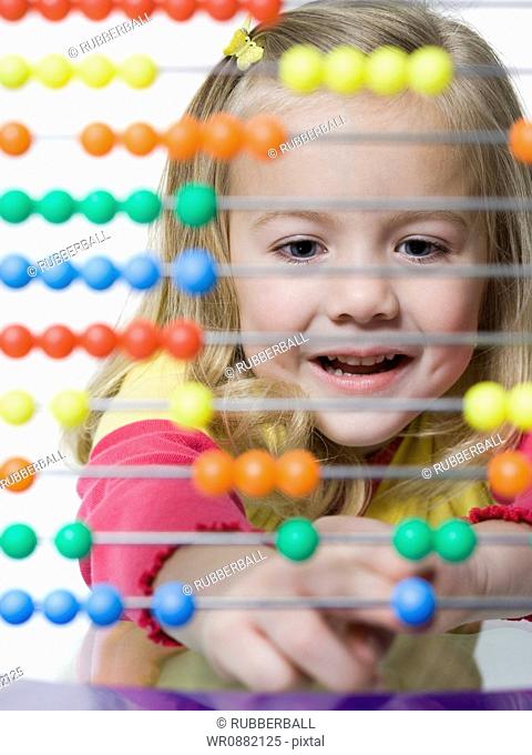 Close-up of a girl playing with an abacus