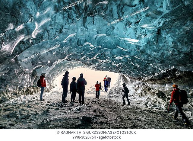 Tourists in The Crystal Cave, Breidamerkurjokull Glacier, Iceland. Emerald Blue Ice and Ash is part of Breidamerkurjokull
